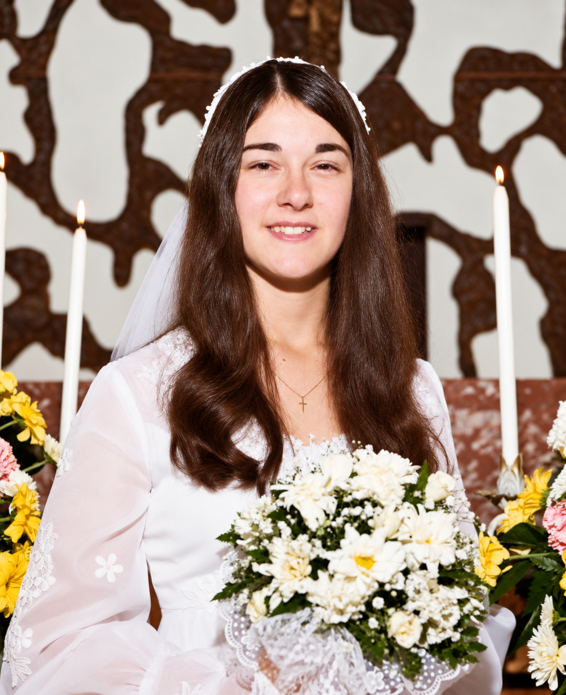Cindy with her bouquet in candlelight