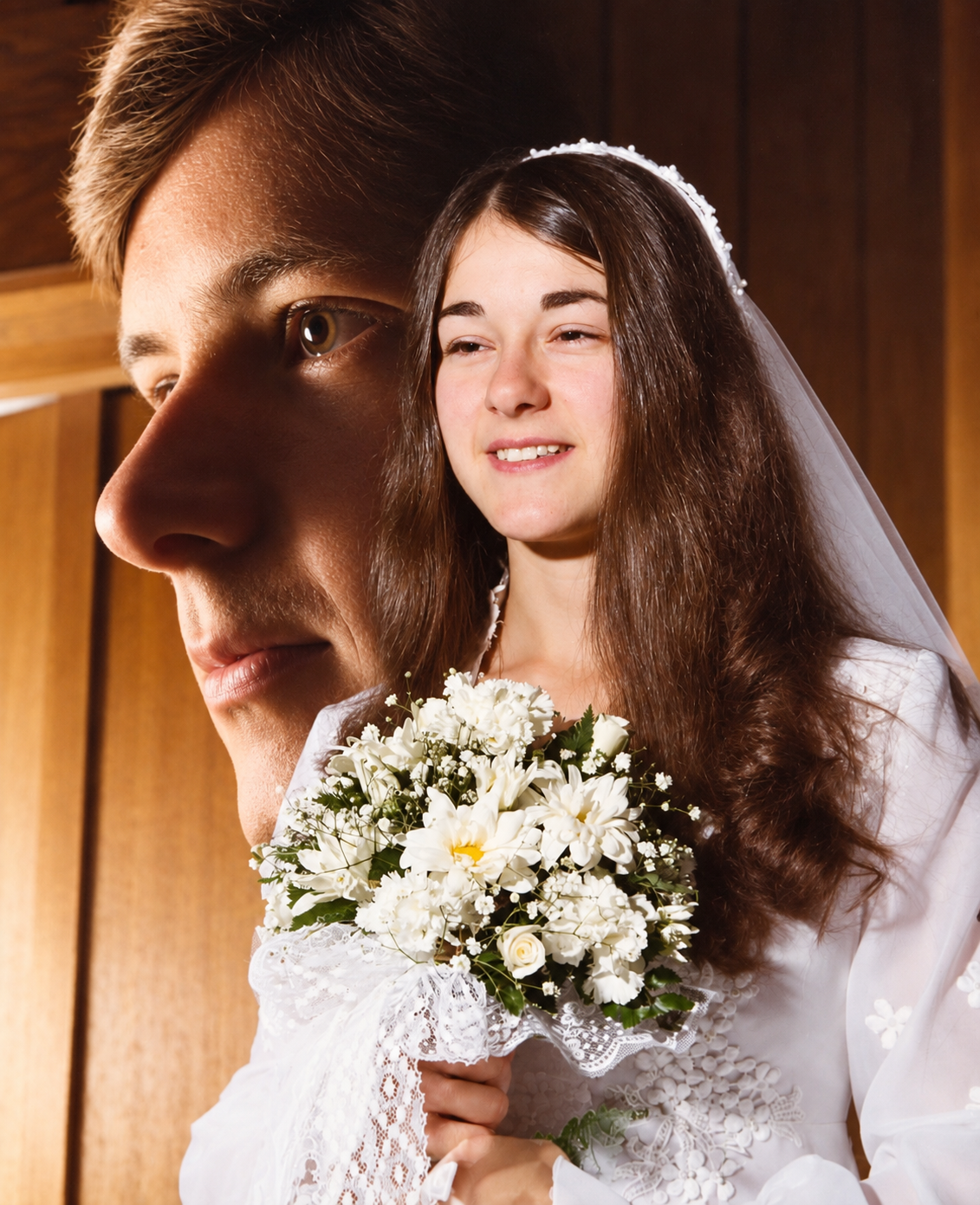 An artistic wedding portrait of Cindy and Ray with Cindy’s bouquet
